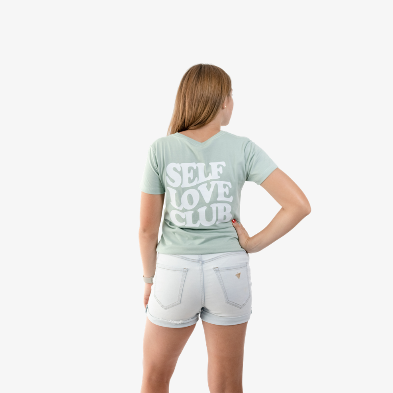 Polo mujer de algodón color verde agua, vista posterior, diseño casual de manga corta.